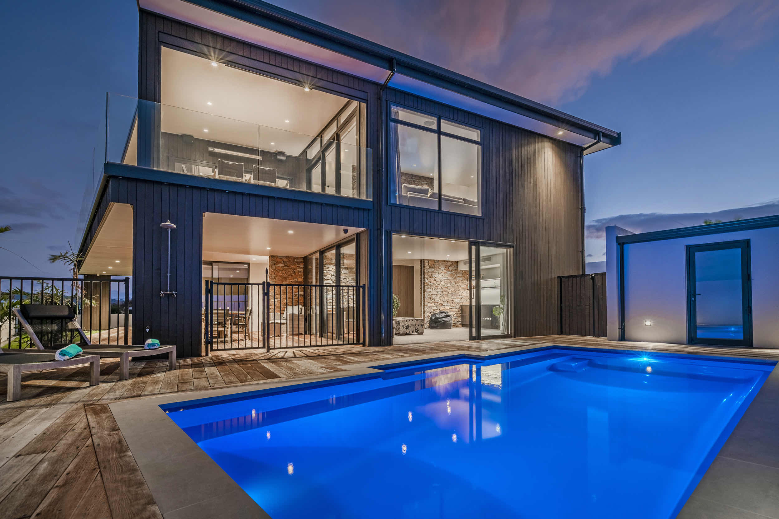 Pool and rear elevation at dusk